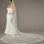 Beaded Leaves Cathedral Wedding Veil Woman wearing a wedding dress with a long veil on a gray background