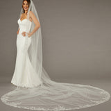 Beaded Leaves Cathedral Wedding Veil Woman wearing a wedding dress with a long veil on a gray background