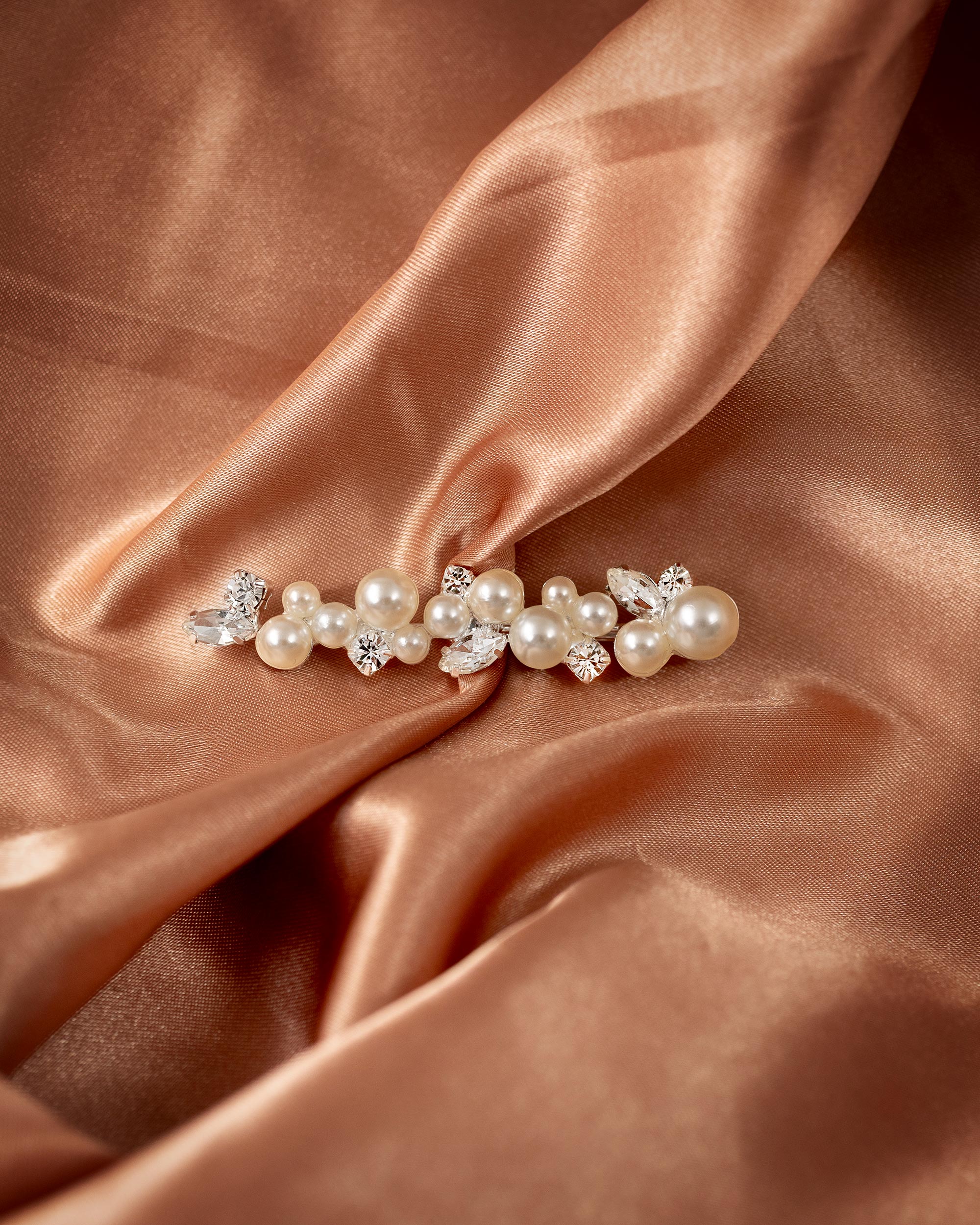 Bridal Bobby Pin with Ivory Pearls A pearl and crystal hair claw clip styled on draped champagne satin fabric.