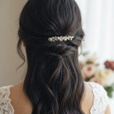 Bridal Bobby Pin with Ivory Pearls A woman shown from behind wearing a half-up hairstyle with a decorative hair accessory made of small white pearls and metallic beads, paired with a white lace top.