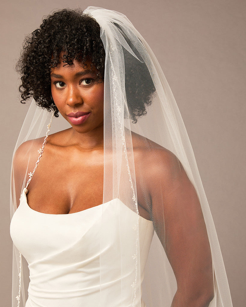 Zig Zag Teardrop Pearl Trimmed Cathedral Bridal Veil Woman wearing a wedding dress with a veil against a neutral background