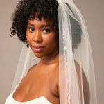 Zig Zag Teardrop Pearl Trimmed Cathedral Bridal Veil Woman wearing a wedding dress with a veil against a neutral background