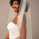 Zig Zag Teardrop Pearl Trimmed Bridal Veil Woman wearing a wedding dress with a veil against a plain background