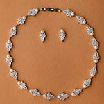 Jewelry set with necklace and earrings on a brown background