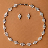 Jewelry set with necklace and earrings on a brown background