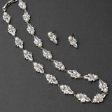 Pearl and crystal necklace with matching earrings on a dark background