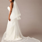 Royal Cathedral Horsehair Trim Two Layer Veil 3 inch ribbon Woman wearing a wedding dress with a long veil against a plain background