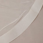 Two Inch Horsehair Trim Waltz Veil Close-up of white fabric on a beige background