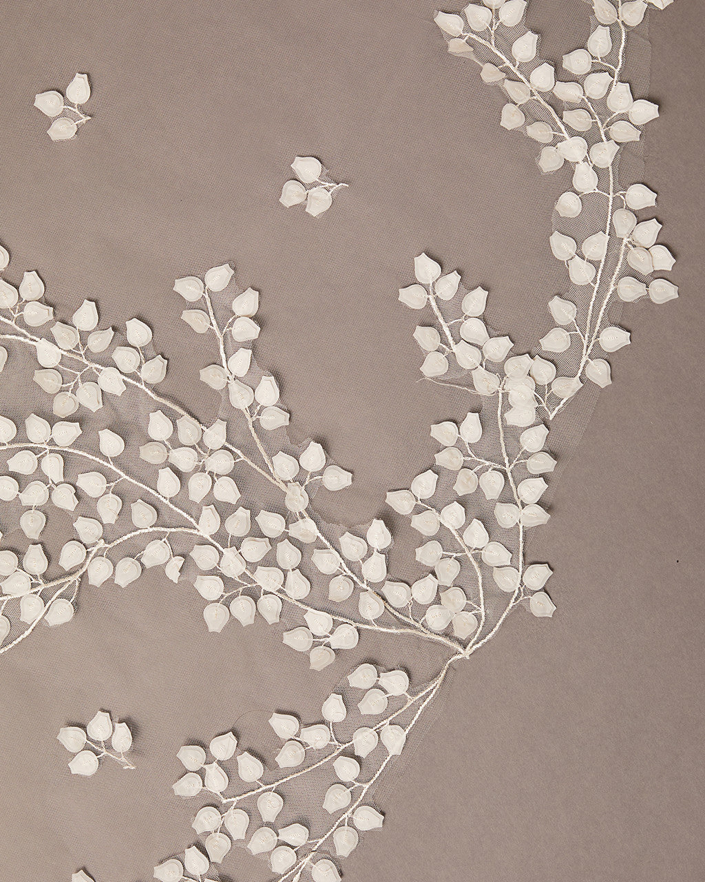 Clover Cut Regal Cathedral Veil with Organza Vines floral branches on a beige background