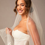 Clover Cut Regal Cathedral Veil with Organza Vines Woman wearing a  wedding dress with a veil against a neutral background