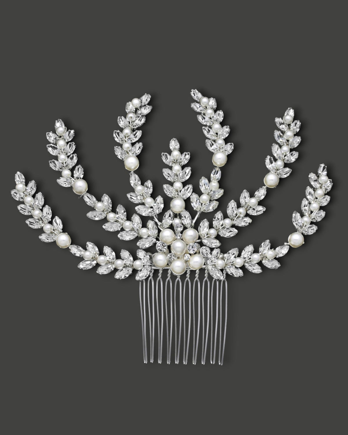 Decorative hair comb with pearls and crystals on a dark background