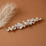 Bridal Bobby Pin with Marquise Jewels & Pearls A bridal hair claw clip decorated with faux pearls and clear marquise and round crystals, styled on a warm brown textured background with dried pampas grass.