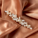 Bridal Bobby Pin with Marquise Jewels & Pearls A pearl and crystal floral hair accessory brooch with silver-toned metal, displayed on draped rose gold satin fabric.