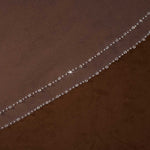 Bridal Veil with Double Crystal Trim Cassandra Lynne A close-up of a brown sheer mesh fabric with a delicate diagonal line of small clear rhinestones or beads along one edge.