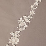 Mantilla Bridal Veil with Sequined Lace Decorative floral lace trim on a beige background